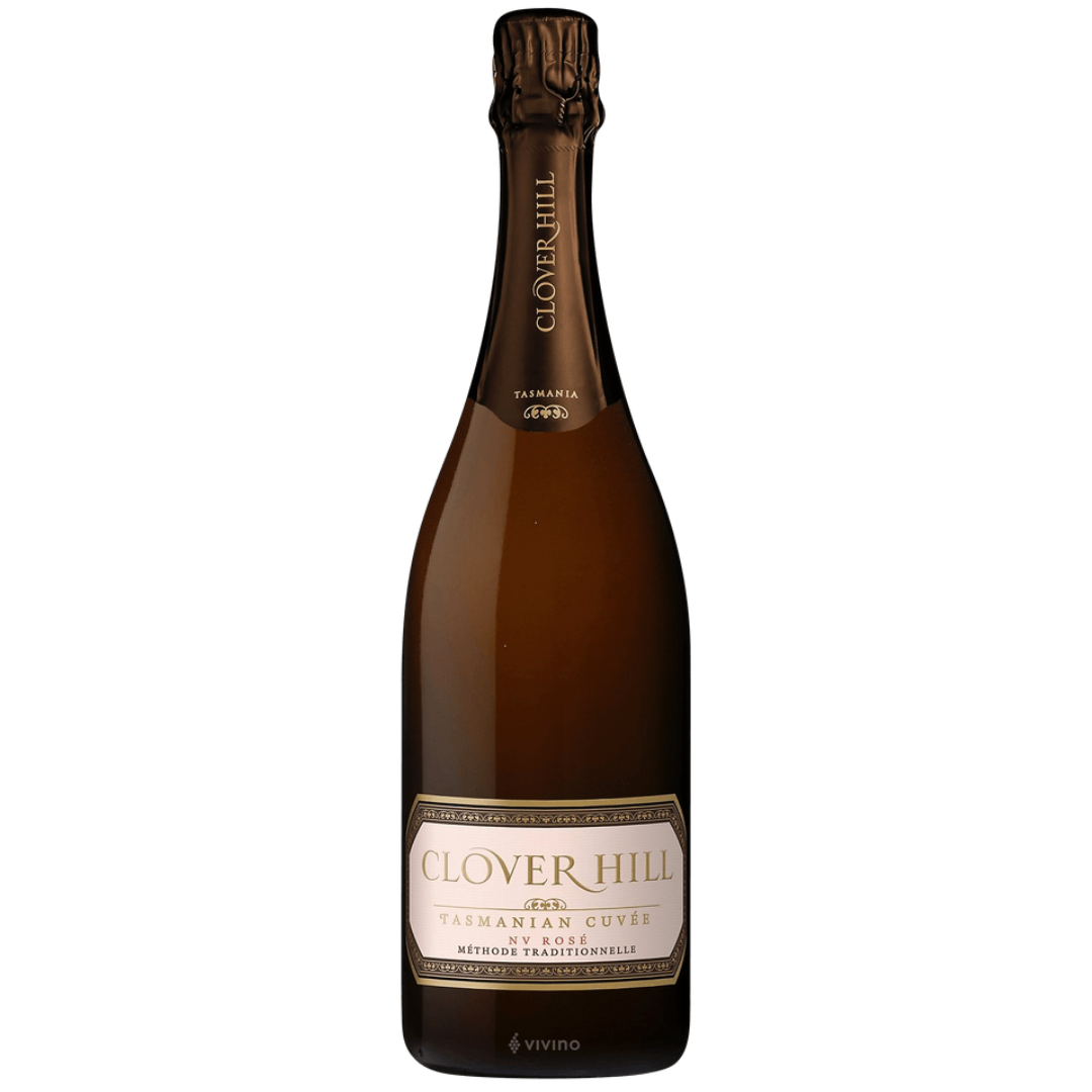 A bottle of Clover Hill Sparkling Wine from Flowers on Norton St features a dark foil-wrapped top. The white label is adorned with gold text, highlighting an elegant and traditional design that embodies the refined charm associated with Clover Hill.