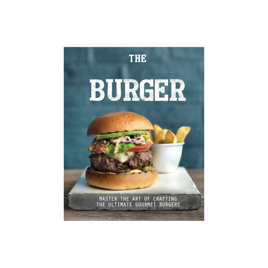 The cover of the cookbook, "The Handcrafted Burger," by Flowers on Norton St entices fast-food enthusiasts with a gourmet burger showcasing beef, lettuce, tomato, cheese, and sauce on a wooden board set against a blue background. In the background, an enticing cup of fries completes the scene.