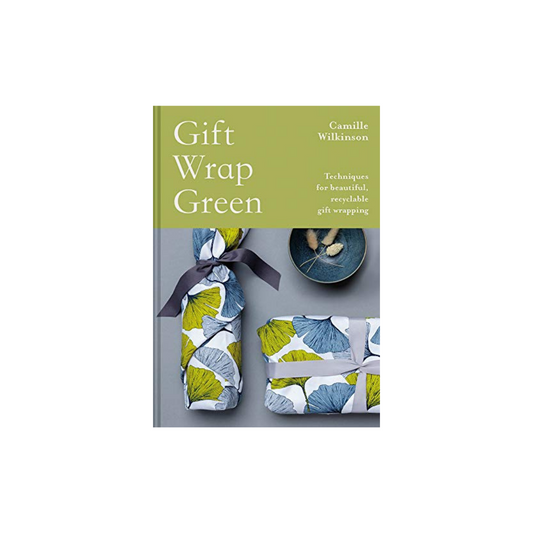 The book "Gift Wrap Green" from Flowers on Norton St, authored by Camille Wilkinson, explores eco-friendly gift wrapping techniques. Its cover features sustainable materials with two gifts adorned in floral paper and bows, set against a gentle green backdrop.