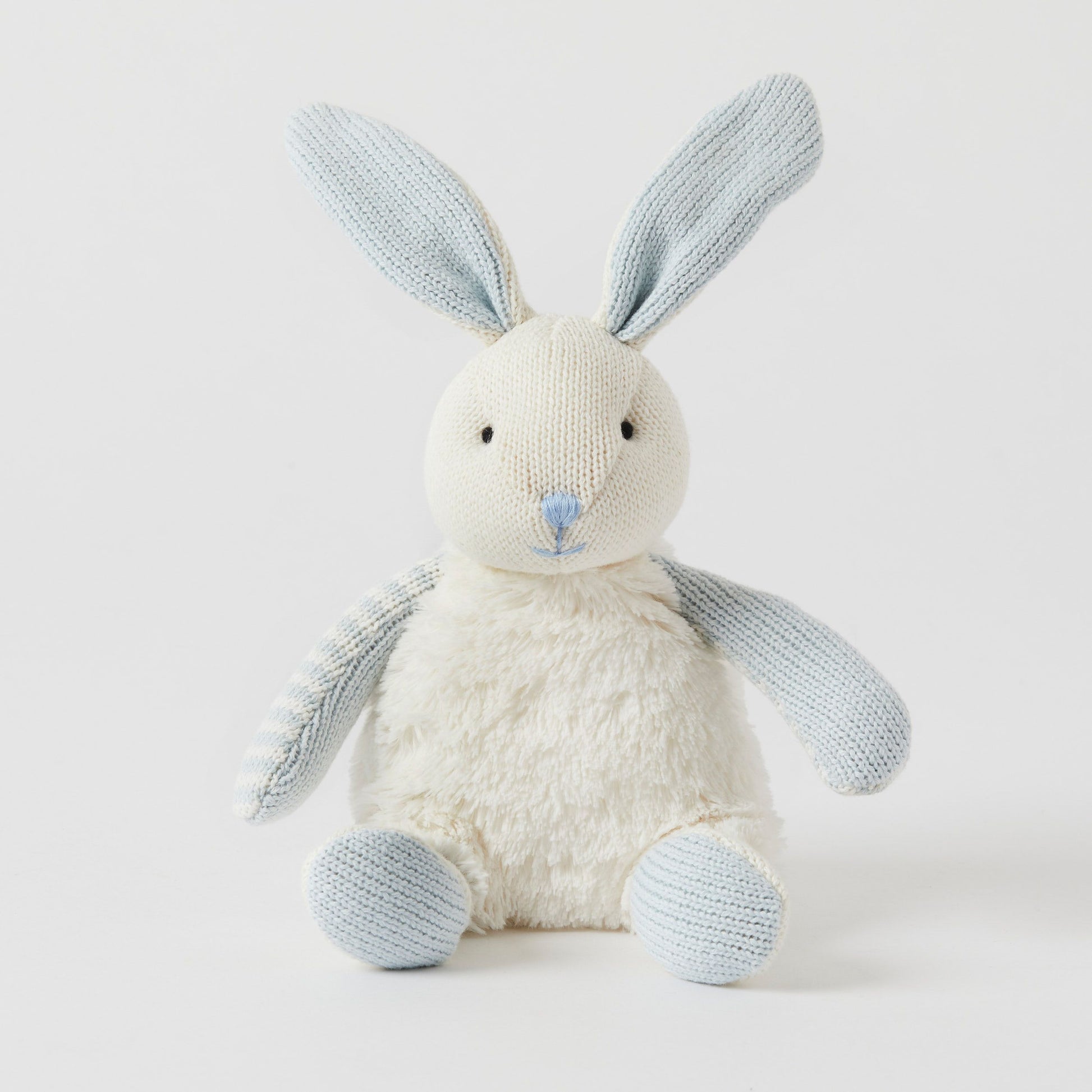 The Baby Bunnies by FlowersonNortonSt are soft, plush toys made from ultra-soft cotton. They feature light blue knit ears, arms, and feet, along with a cream-colored fuzzy body and a blue stitched nose. These bunnies invite all the cuddling while sitting upright against a plain white background.