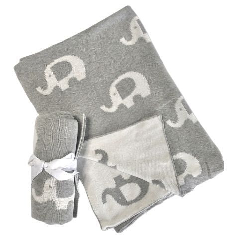 The Ellie Baby Blanket by FlowersonNortonSt is a cuddly gray blanket featuring white elephant patterns, accompanied by a smaller matching rolled-up blanket tied with a white ribbon.