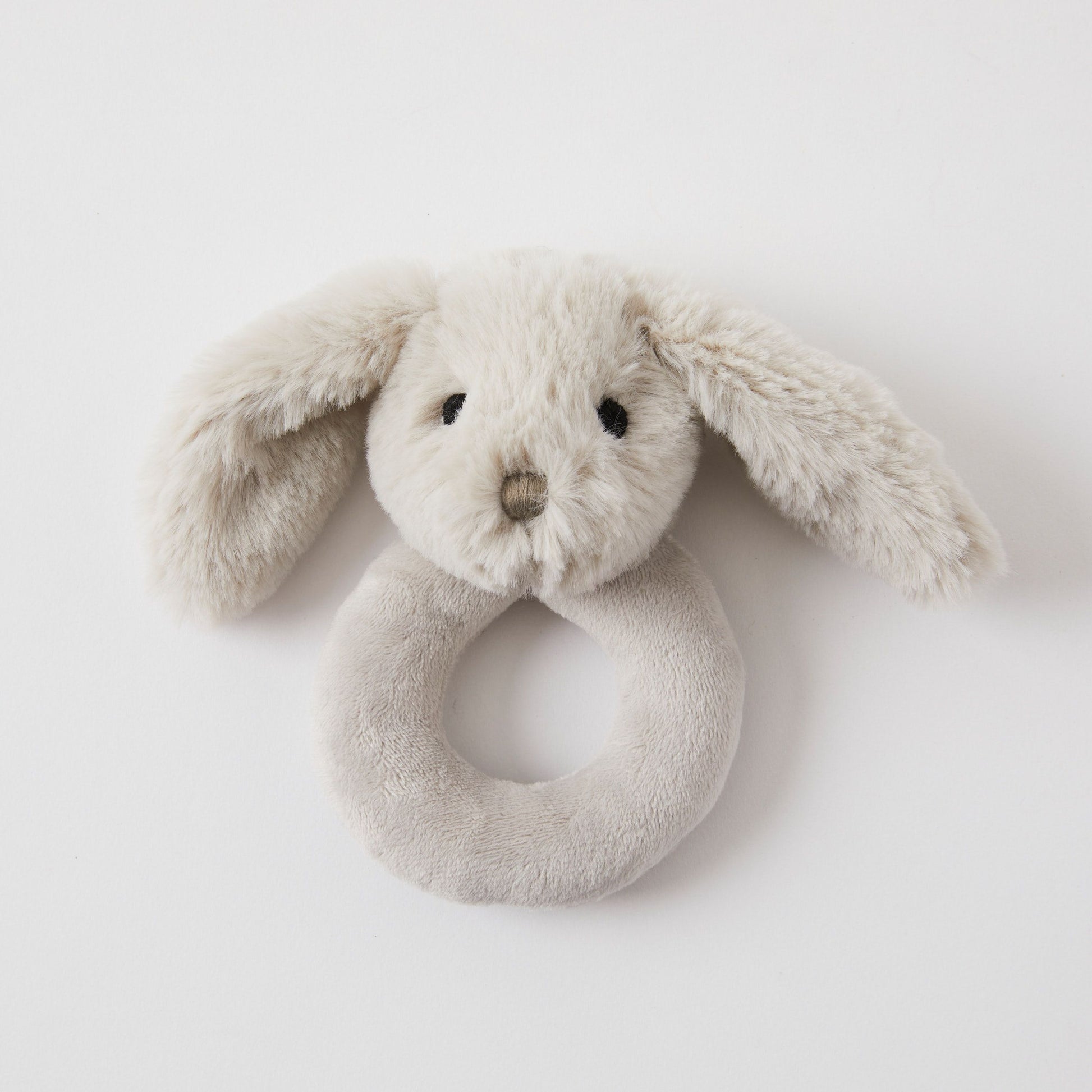 This Baby Bunny Rattle by FlowersonNortonSt features an ultra-soft design shaped like a bunny head with long floppy ears and is made from light gray fabric. The loop at the bottom ensures easy gripping, while the small embroidered eyes and nose make it an ideal gift for new parents.