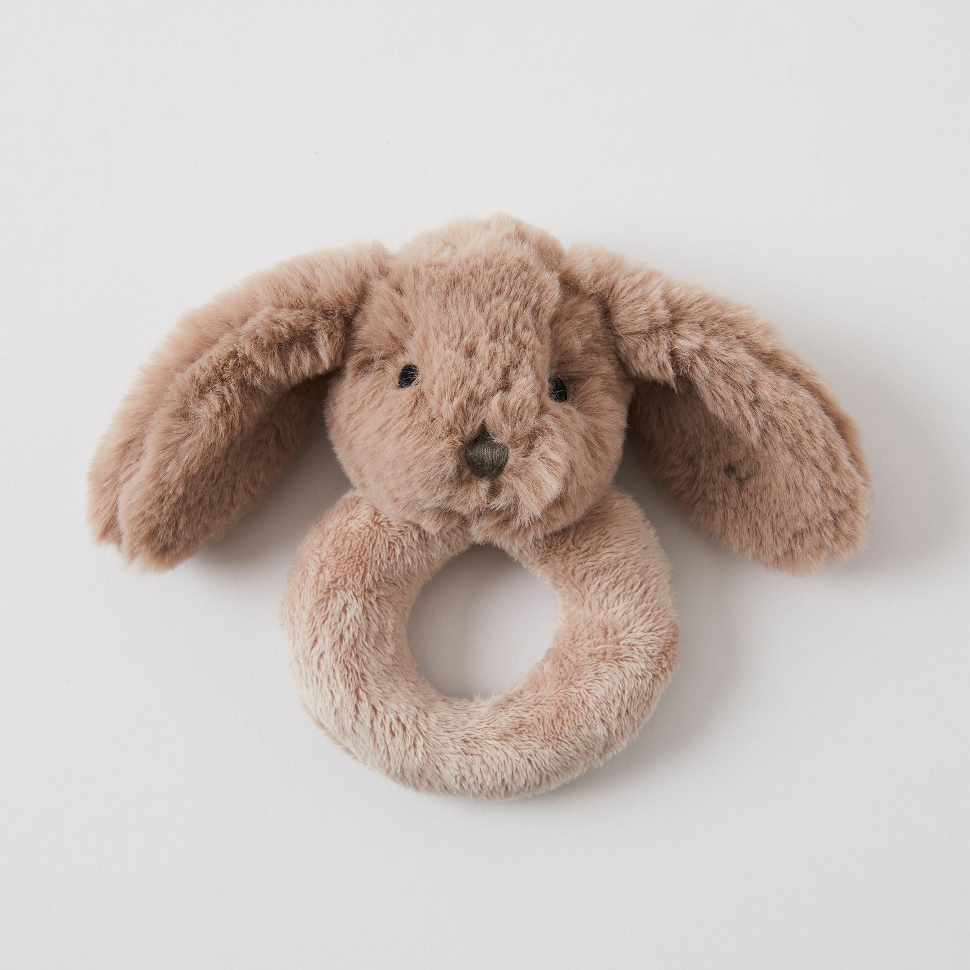 The Baby Bunny Rattle by FlowersonNortonSt is an ultra-soft hand toy featuring a brown bunny with long, floppy ears. Its circular, textured body is perfect for infants to hold and shake. With a sweet, simple face and stitched eyes, it makes an ideal gift for new parents seeking charm and cuddliness.