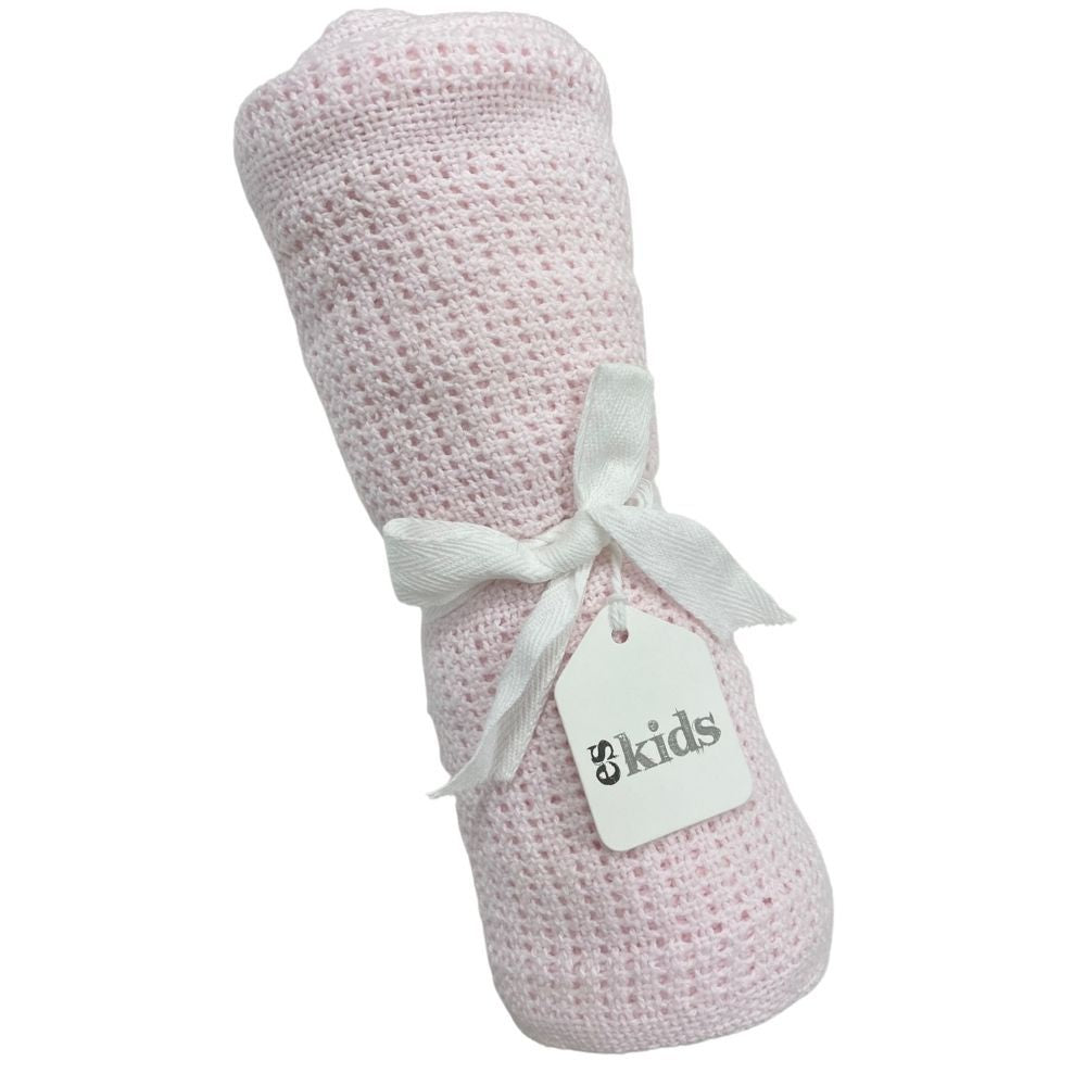 A plush, pink woven baby blanket ideal for snuggling is neatly rolled up and secured with a white ribbon. Attached to the ribbon is a tag labeled "FlowersonNortonSt." The blanket features a gentle, cuddly textured pattern.