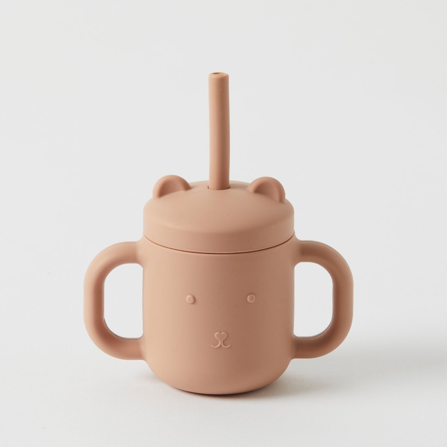 Introducing the Silicone Sippy Cup with Straw by Flowers on Norton St—a light brown sippy cup crafted from non-toxic, BPA-free materials. Designed with two handles and a bear face lid complete with bear ears, this cup includes a centrally placed straw for safe sipping.