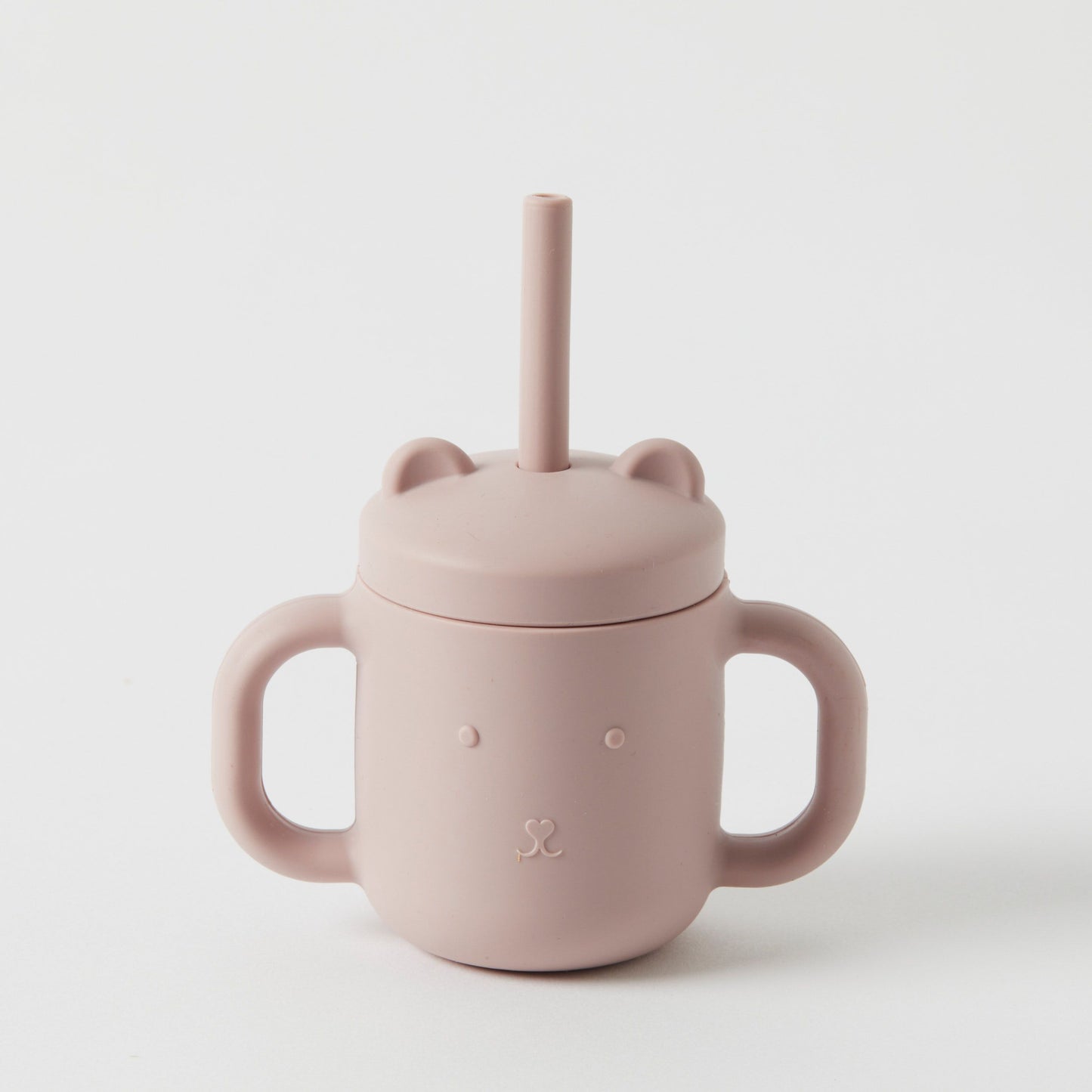 Product Data: A charming Silicone Sippy Cup with Straw by Flowers on Norton St. It features a light pink color, an adorable bear face design, and two convenient handles. Made from BPA-free, non-toxic silicone, it comes with a matching straw lid adorned with cute bear ears. The product is displayed against a plain white background.